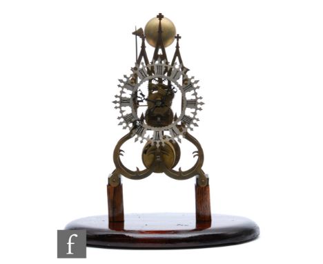 A late 19th Century brass cathedral skeleton clock, single fusee movement striking on a bell, mounted on later blocks and ova