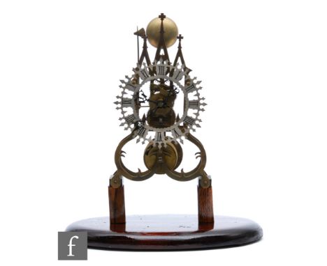 A late 19th Century brass cathedral skeleton clock, single fusee movement striking on a bell, mounted on later blocks and ova