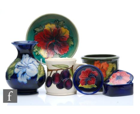 Six pieces of assorted Moorcroft Pottery comprising a vase of globe and flared shaft form decorated in the Hibiscus pattern, 