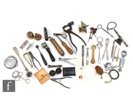A late 19th Century carved Coquilla nut pomander, a butter stamp, a cherry picker, two wooden Codd bottle plungers, two bull 