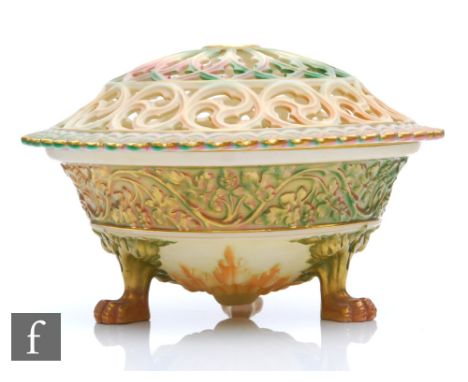 A Royal Worcester shape G846 pomander, the bowl raised to three paw feet, with a band of moulded grape vines in green and mat