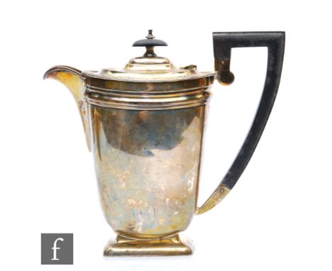 A hallmarked silver coffee pot of plain form with dart border and angular wooden handle, weight 17.5oz, Sheffield 1940,&nbsp;