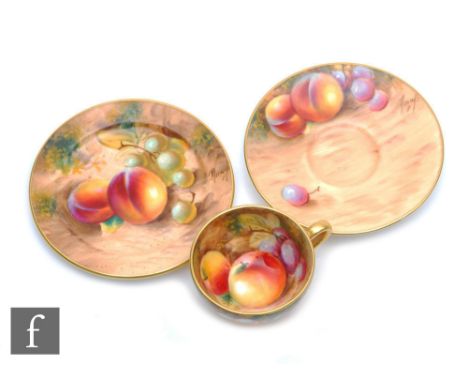 A miniature Royal Worcester Fallen Fruits cabinet trio, the interior of the cup decorated with apples and grapes and to the e