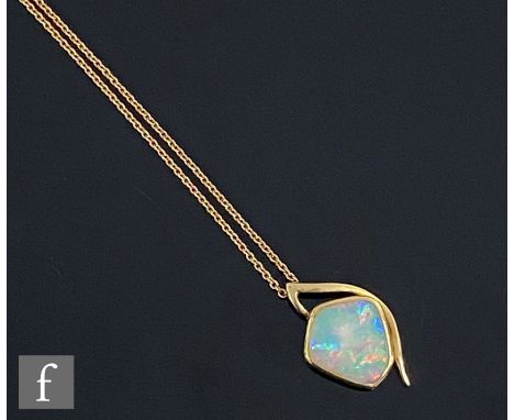 An 18ct irregular cut opal pendant, collar set stones, length 12mm, suspended from an 18ct fine belcher chain, total weight 4