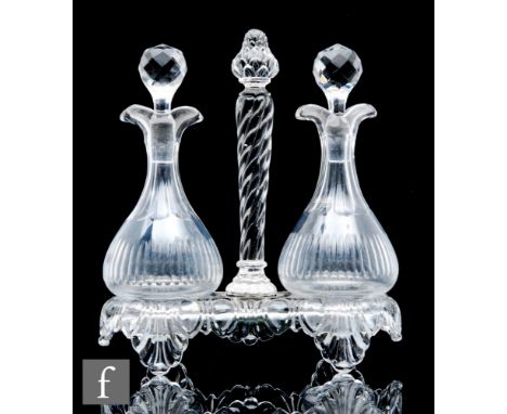 A late 19th to early 20th Century St Louis crystal glass oil and vinegar set with two footed globe and shaft bottles with sli