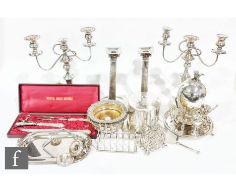 A parcel lot of assorted silver plated items to include a pair of candlesticks, a pair of three light candelabra, bottle coas