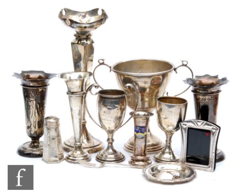 A parcel lot of assorted hallmarked silver items to include trumpet and other vases, trophies, a pepper etc, total weight of 