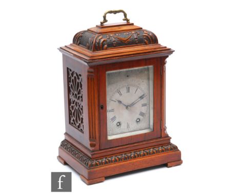 A late 19th Century carved walnut cased striking mantle clock, eight day movement, silvered engraved dial enclosed by a glaze