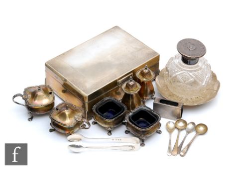 A parcel lot of assorted hallmarked silver items to include a cigarette box, a six piece cruet set, a small pin dish, a match