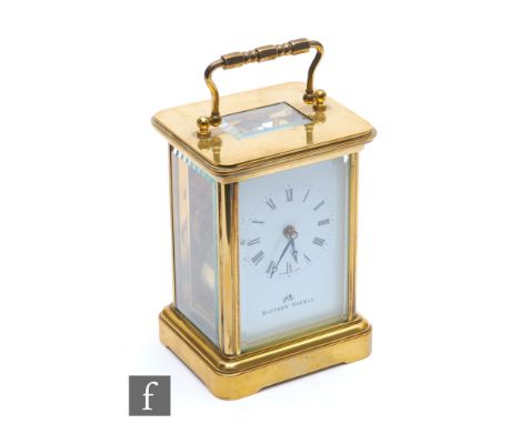 A 20th Century French brass carriage clock by Matthew Norman, white dial on bracket plinth, height 11cm. 