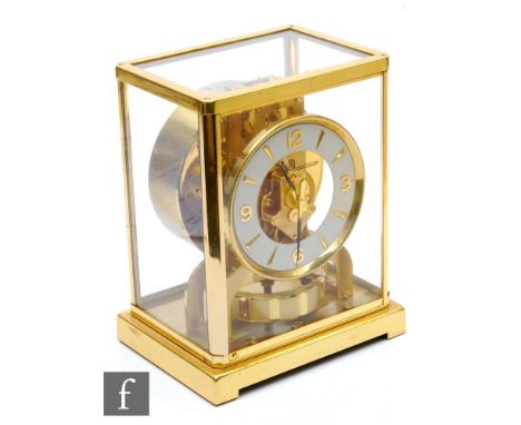 A Jaeger-Lecoultre Atmos clock, circular white dial in brass glazed case, on plinth base, height 22.5cm. 