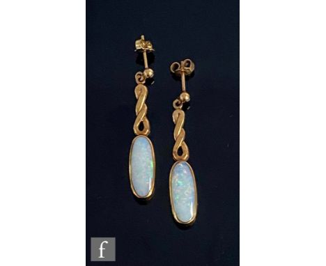 A pair of 9ct hallmarked opal drop earrings, elongated oval opals suspended from a twisted gold panel, weight 7g, length of d