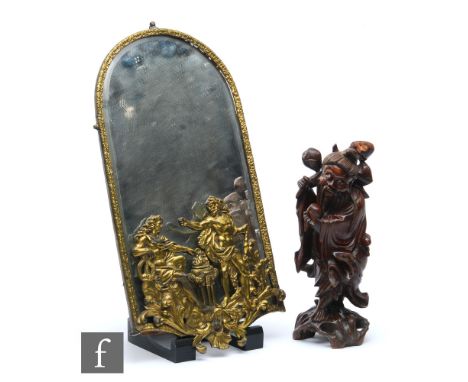 A 20th Century brass arch shaped wall mirror mounted with two classical figures near a brazier, 51cm x 30cm, and a Japanese r