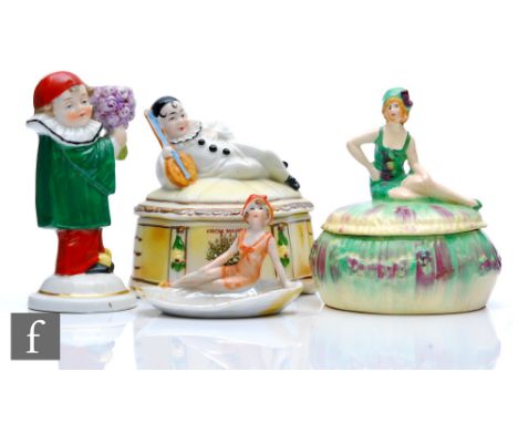 Four 1930s Art Deco trinkets comprising a bathing belle powder bowl and cover, a pin dish with a bathing belle sat on a shell