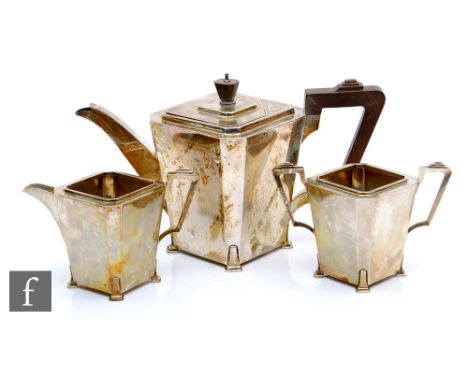 An Art Deco hallmarked silver three piece tea set of tapering rectangular plain form each raised on four strut feet, total we