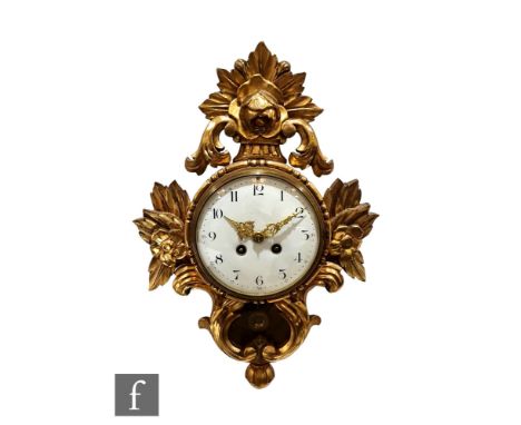 A 19th Century French painted gilt pine cartel clock, white circular Arabic numeral dial below a floral pediment, height 43cm