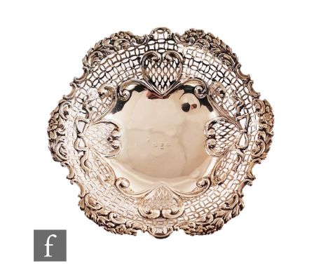 A Victorian hallmarked silver circular bowl with pierced and foliate embossed borders, weight 17.5oz, diameter 30cm, all rais