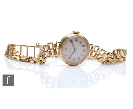 A lady's 9ct hallmarked manual wind Tudor wrist watch, Arabic numerals to a silvered circular dial and a 9ct bracelet stamped
