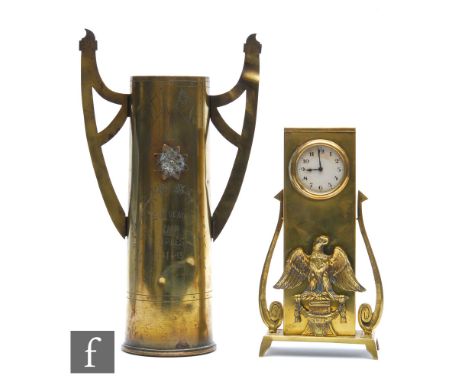 An early 20th Century continental brass Secessionist desk/mantle clock mounted with a Prussian eagle, thirty hour movement on