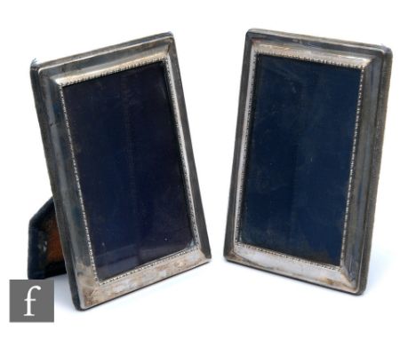 A pair of hallmarked silver rectangular easel photograph frames with internal beaded borders, height 18cm, Sheffield 2002. (2