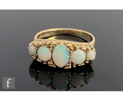 A 9ct hallmarked Victorian style opal five stone boat shaped ring, graduated claw set stones, weight 3.7g, ring size O. 