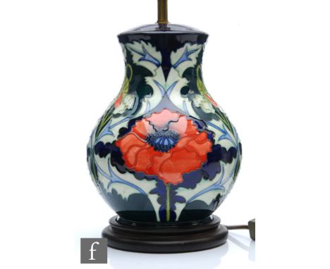 A Moorcroft Pottery table lamp decorated in the Poppy pattern designed by Rachel Bishop, marks obscured by affixed wooden pli