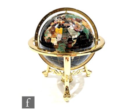 A modern table globe on black ground, inset with lapis lazuli and other stones, in a suspended brass frame with compass, heig