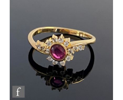 A 14ct ruby and diamond cluster ring, central oval collar set ruby within a diamond border and diamond set shoulders, weight 
