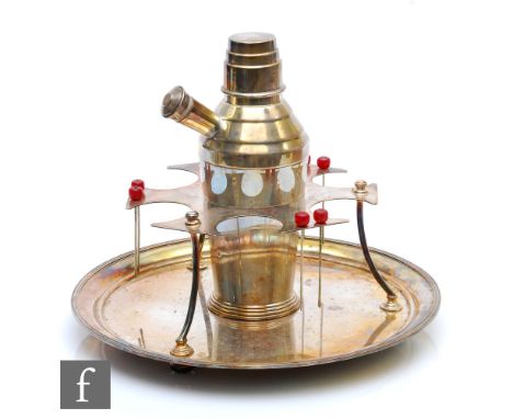 A mid 20th Century silver plated cocktail shaker and stand, the central shaker to a frame supporting six cocktail sticks abov