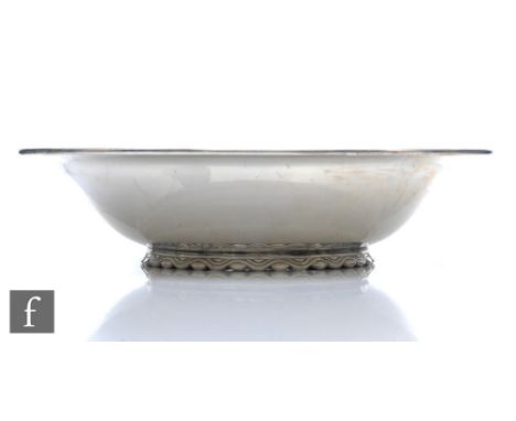 A hallmarked silver circular bowl of plain form, weight 16.5oz, diameter 23.5cm, all raised to a scroll detailed pedestal foo