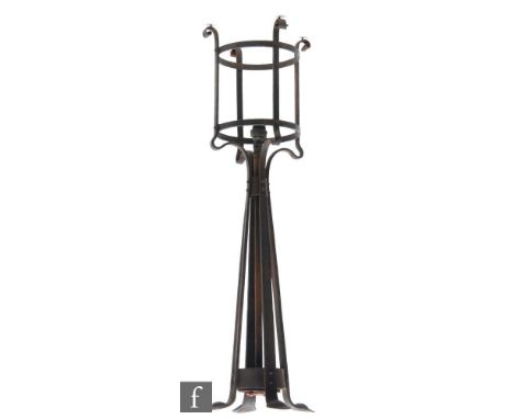 A large early 20th Century Art and Crafts wrought iron newel post or ceiling light with whiplash supports and curled terminal