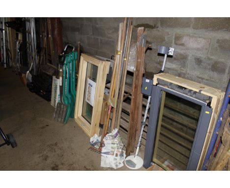 A bundle of long handled gardening tools and a wooden step ladder 