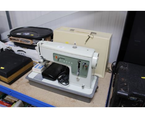 A singer sewing machine with manual and accessories