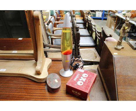A lava lamp; a vintage Oxo tin and a vintage Macintosh assortment tin 
