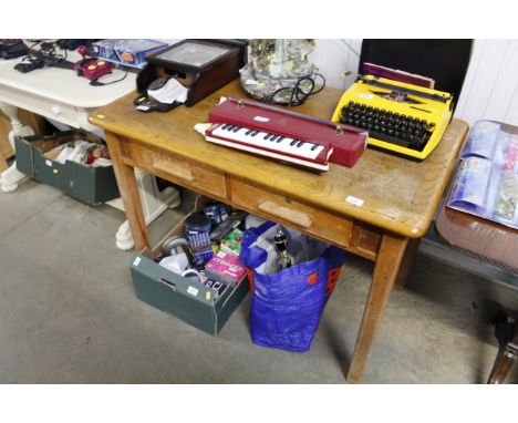 A 20th Century light oak two drawer writing table