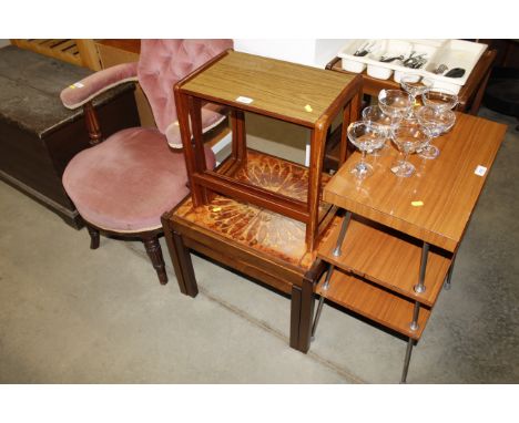 A nest of two teak effect occasional tables; and two tile top coffee tables 