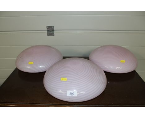 Three pink glass light shades of swirl design