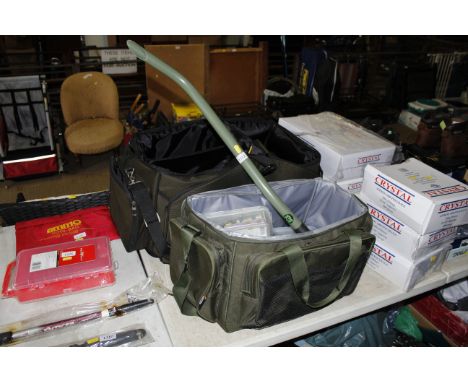 A TF Gear fishing tackle bag and contents of PVA mesh, various fishing line, bit alarms to include Fox, hair rigs, fishing we