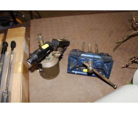 A bench vice and a blow lamp