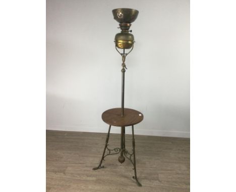 ARTS &amp; CRAFTS BRASS STANDARD OIL LAMP, theshade embossed with flora and inset three coloured stones, on a telescopic supp
