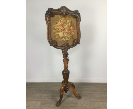 VICTORIAN WALNUT POLE FIRESCREEN, the scroll and foliate carved frame inset floral woolwork panel, the column support further