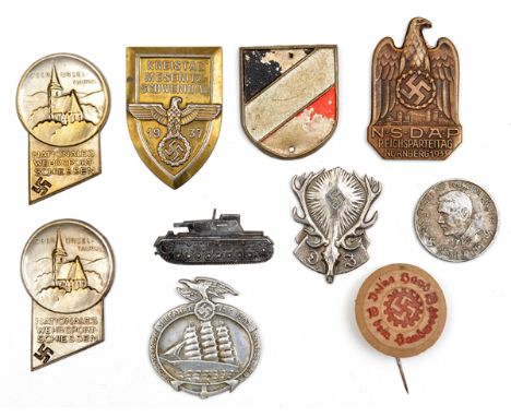 6 Third Reich pin back badges, of pressed tin or aluminium (pins missing); a small bronzed tank badge with bend over wire fit