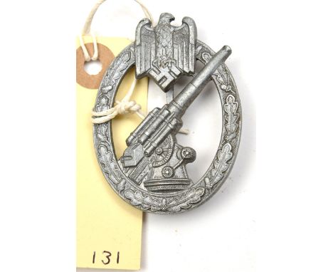 A Third Reich Army Flak badge,  of zinc with good detail and satin grey finish, the flat silvered brass pin stamped “L/21” in