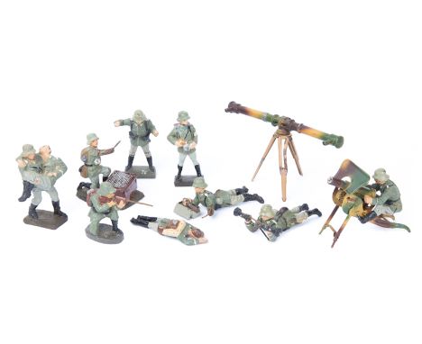 9 Elastolin German Army figures. 2 with range finders, large and small, soldier with wounded soldier, soldier with heavy mach