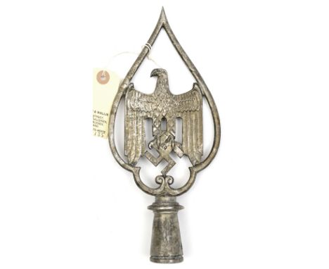 A Third Reich cast aluminium banner top,  in the form of army type eagle and swastika within teardrop shaped surround, on a s