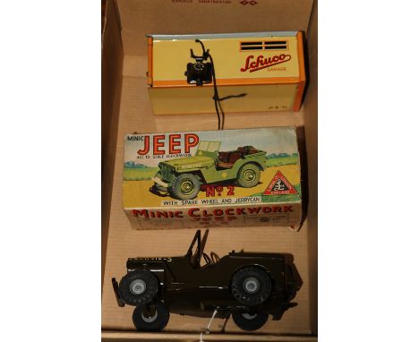 A Schuco Garage and Kommando Anno 2000 Car (No.1500). A tinplate mechanical garage in yellow with grey corrugated roof. Doors