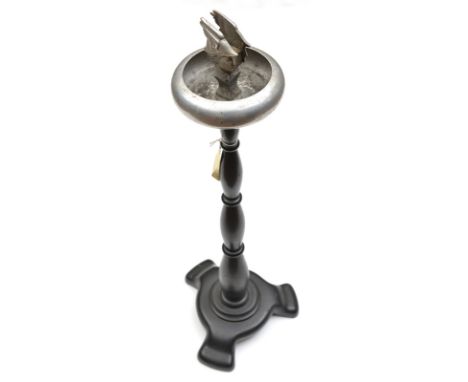 An alloy ashtray/matchbox holder, of HMS Hermes, on turned darkwood stem and pedestal base, the holder in the form of a split
