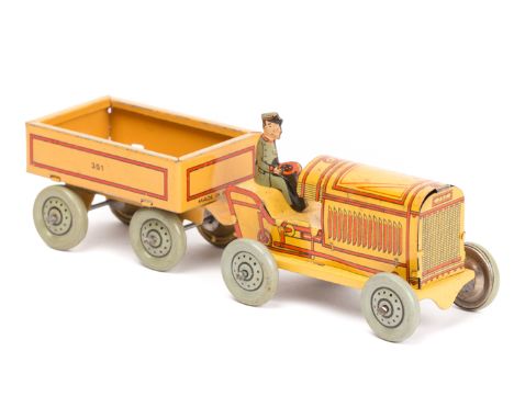 A 1920’s German tinplate penny toy style tractor and trailer. 120mm combined length, four wheeled tractor and four wheeled tr