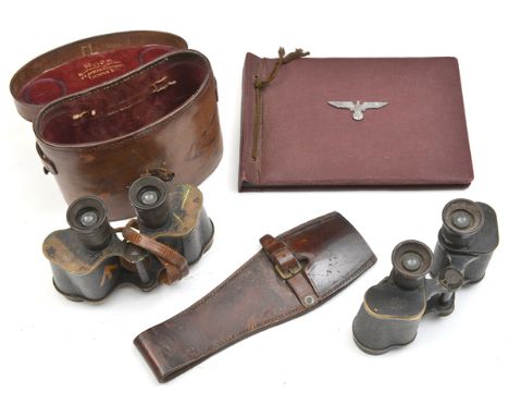 A prismatic binocular, approx 8 x 35, individual eyepiece focus, in leather case, both with WD broad arrow marks; another sim