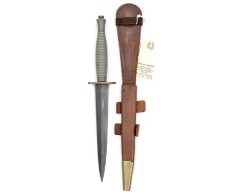 A Third Pattern FS military knife, with blued blade, unmarked bare steel crosspiece, and bare grey metal grip, in its leather
